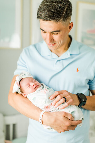 father holding newborn baby