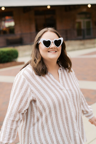 Event coordinator Maya for Raleigh event planning business wearing heart glasses