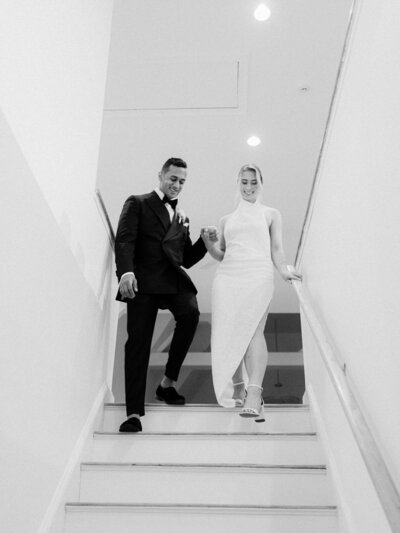 Belle Mer Newport wedding - bride and groom walking down stairs