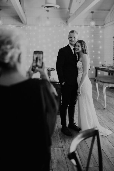 A photographer with a camera up to her face.