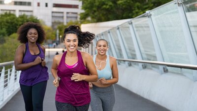 Group of women running outdoors, promoting active lifestyle during menopause.
