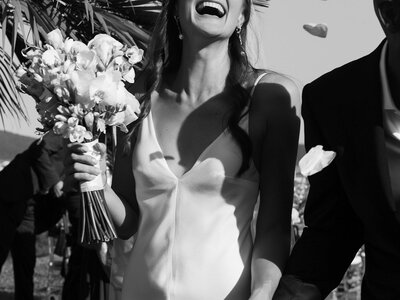 smiling bride holding bouquet during destination wedding photography session in Ibiza