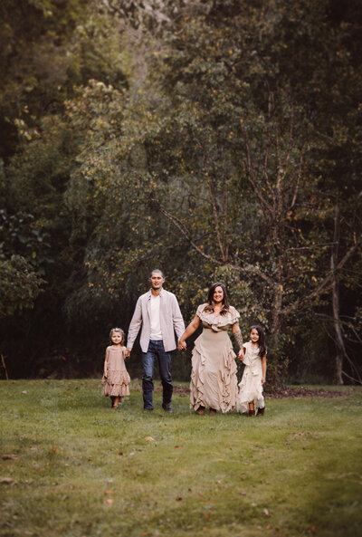 Family Walking hand in hand in a park setting