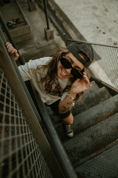 Grunge editorial portrait in urban stairwell, cinematic moody queer photography in Pittsburgh, Pensacola vintage film & Super 8 style