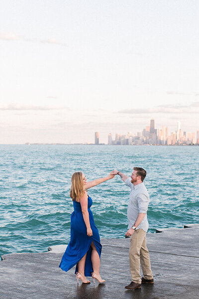 A couple dance in front of the Chicago skyline at Montrose Harbor