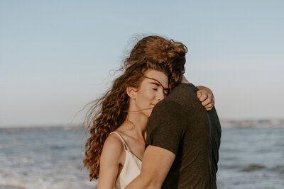 photo of adventurous couple on folly beach by charleston photographer