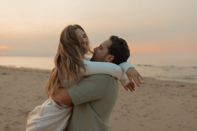 couple embracing on beach in pei for lifestyle photos