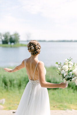 The bride, dressed in her wedding gown, enjoys the warmth and sunshine.