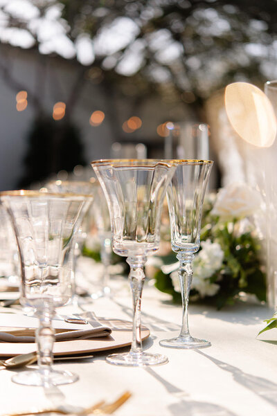 Close up of clear champagne glasses on the reception table.