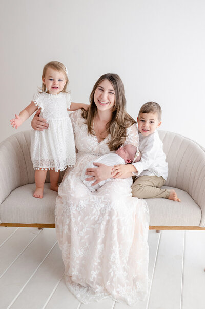 mother and her children during studio newborn portrait session