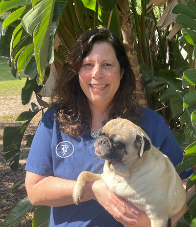 Doctor of Veterinary Medicine Tracy Anderson holding her dog