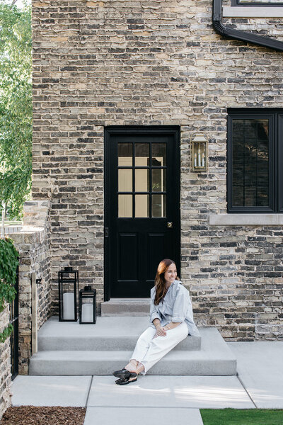 woman sits on porch steps