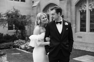 st paul wedding photographer tom thornton photographs bride and groom on their wedding day in black and white smiling toward each other 