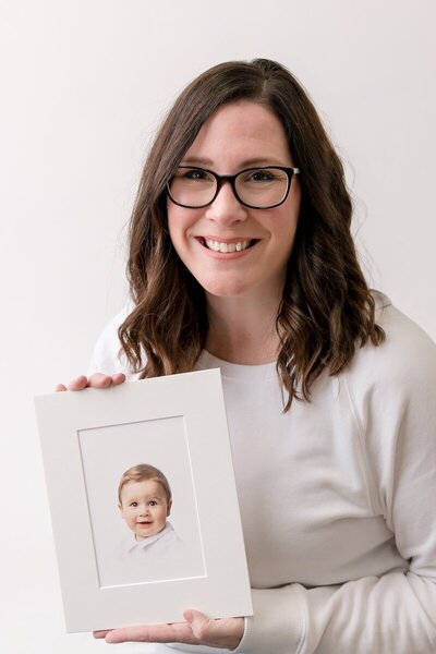 Tiffany Bradley, Savannah photographers, holding framed heirloom portrait