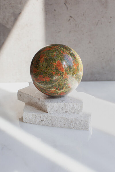 A large jade sphere - our Feng Shui ball, on a quartz slab.