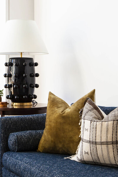 close up with cushions and black lamp