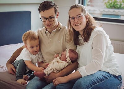 foto van een gezin, een vader en moeder met een peuter en een baby die samen lachen - Foto door Pictures by Lisette
