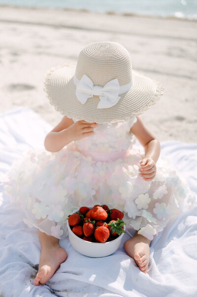 Baby girl playing with flowers by Miami Family Photographer