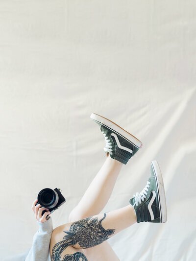 One of the top baltimore photographers, Nicole Simensky, with shoes in the air