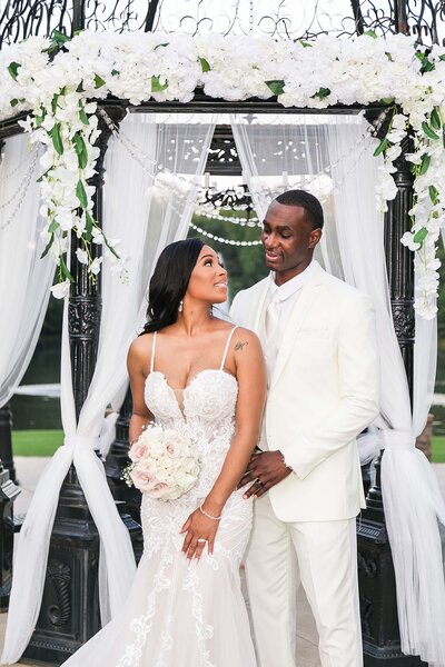 Portrait of Black couple under gazebo at Pristine Chapel on their wedding day photographed by Bonnie Blu Studios