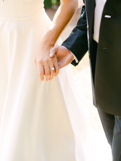 Couple holding hands for their wedding pictures