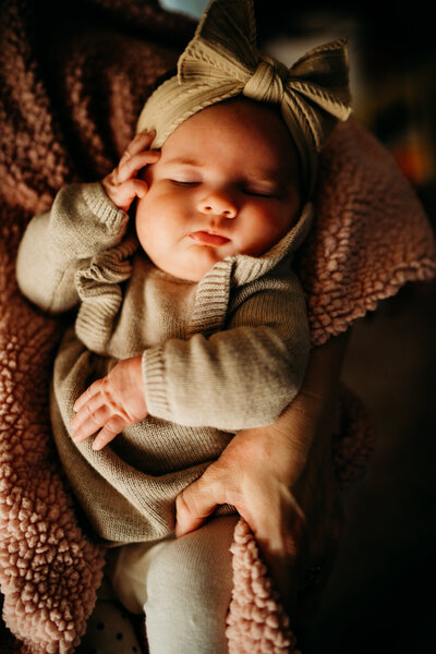 snuggly photo of baby girl during in home lifestyle newborn session in breaux bridge, louisiana