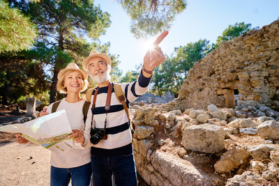 A cheerful couple poses together outdoors, showcasing their enjoyment and satisfaction during their travel adventures, highlighting expert itinerary