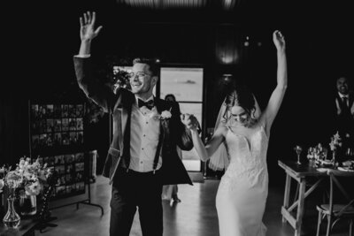 Bride and groom dancing and celebrating at Silchester Farm Wedding venue in black and white