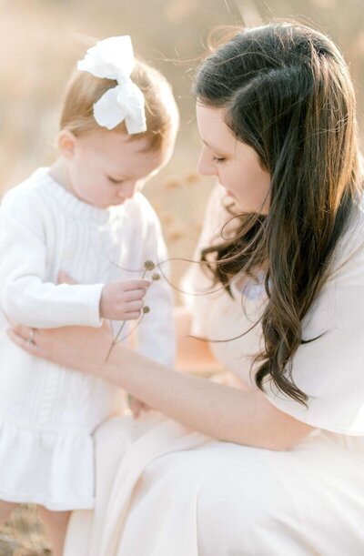 mom playing with daughter during family session with photographer in San Francisco