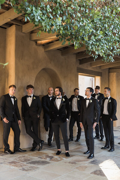 a group of men in wedding suits