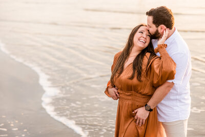 Couple celebrate their engagement  at Galveston Beach in Galveston, Texas.