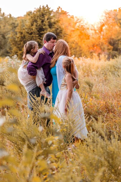 Family standing in a field.