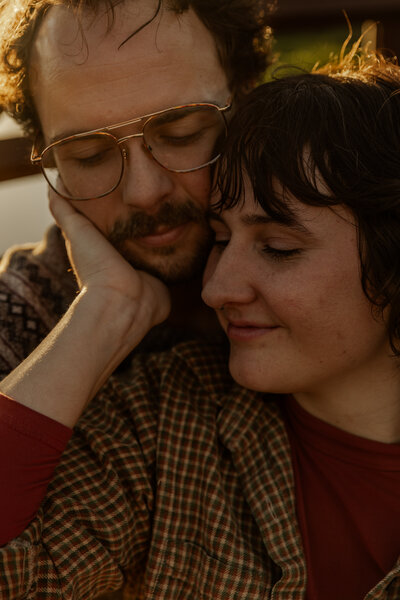 Close up photo of couple holding each other in Southern MN at Golden Hour 