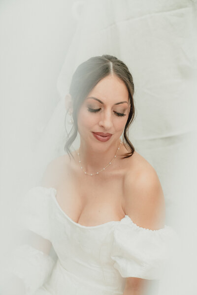 A bride looks softly down 