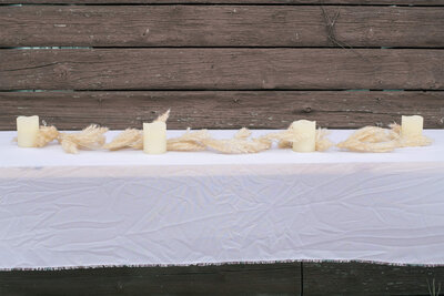 faux wheat strand on table with candles