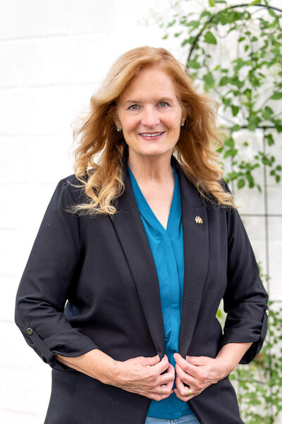 Headshot of woman standing outside, running for a re-election campaign in Greenwich, CT.