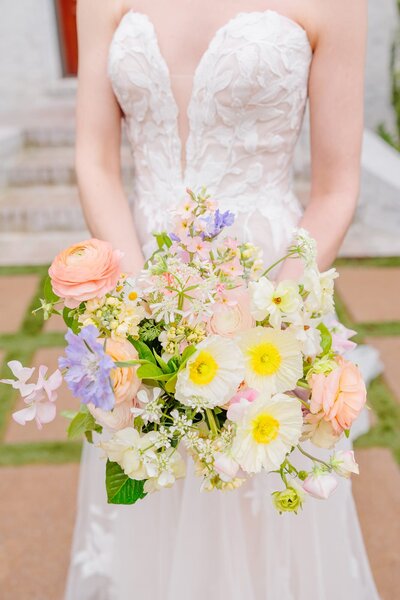 A spring wildflower bouquet with white, pink, and purple flowers.