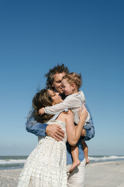 Family embracing with a group hug taken by engagement photography florida