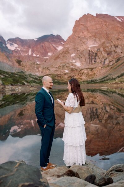 Wedding and Elopement Photography, Bride and groom exchange vows during Colorado intimate wedding.