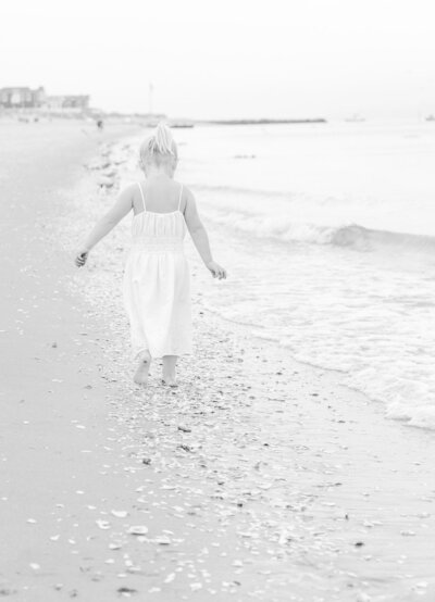 girl in white dress walking away from the camera