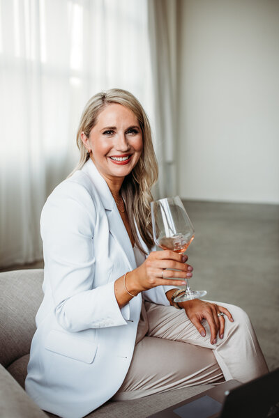 legal career coach - brittany holding glass of wine