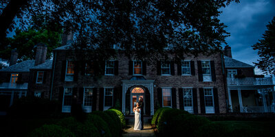 Portrait of couple in front of their dream wedding venue