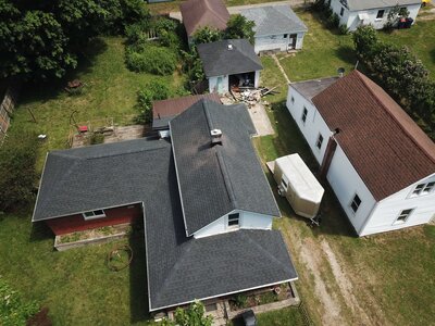 Aerial view of roofing project on multiple buildings by Black Bear Roofing & Exteriors.