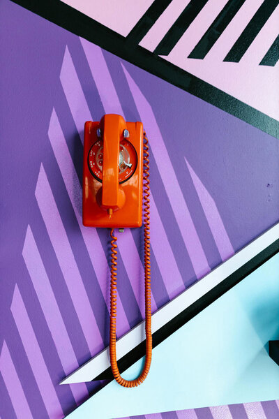 Stock image of an orange rotary phone