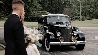 Elegant couple leaves for grand exit in old fashioned car