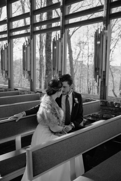 romantic elopement photo of a bride and groom looking at each other on a mountain