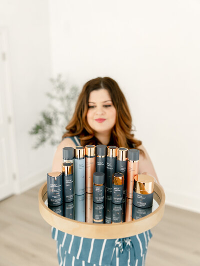 Woman holding a tray of products for skincare banding photoshoot