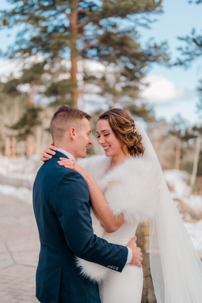 Groom and Bride pose for the camera holding one another and smiling.