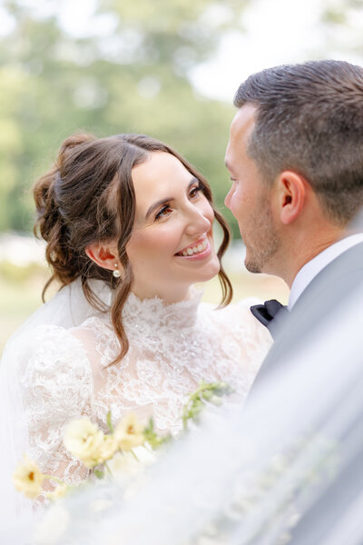 bright light and airy wedding photo of bride with boquet
