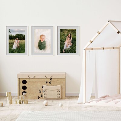 Springfield MO newborn photography of framed photos of framed maternity and newborn in playroom